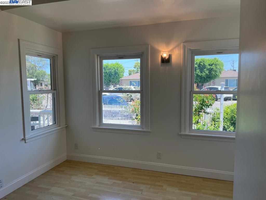 209 McLeod Street Livermore, CA 94550 - Photo 19 of 26 a view of an empty room with wooden floor and windows