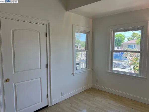 an empty room with windows and closet