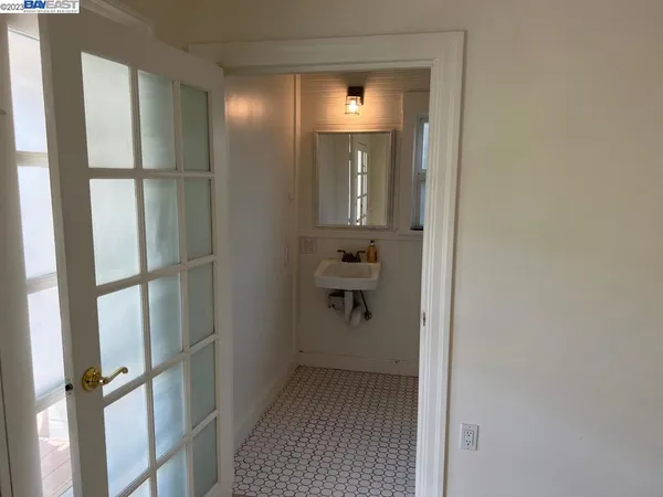 a bathroom with a sink a toilet and mirror