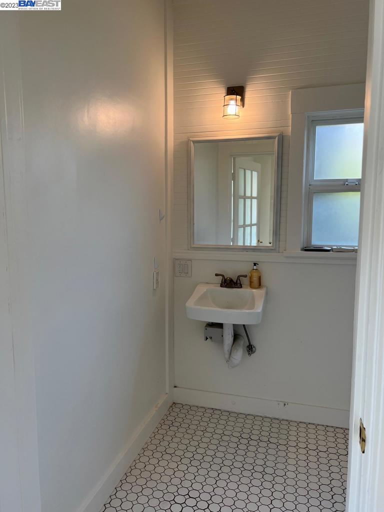 209 McLeod Street Livermore, CA 94550 - Photo 25 of 26 a bathroom with a sink a toilet and mirror