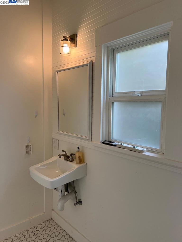 209 McLeod Street Livermore, CA 94550 - Photo 26 of 26 a bathroom with a sink a mirror and a window