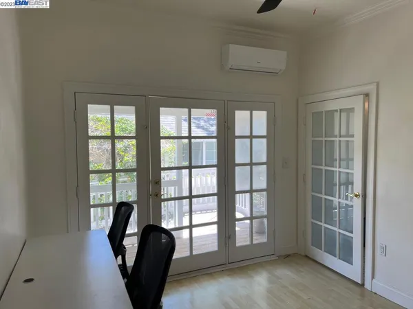 a view of a livingroom with wooden floor and a window