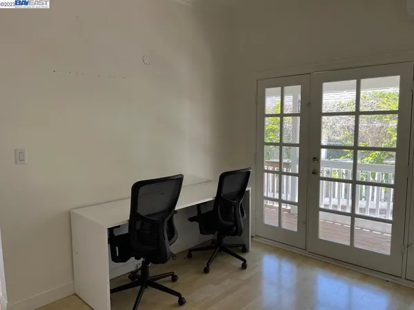 a view of a workspace with furniture and a window