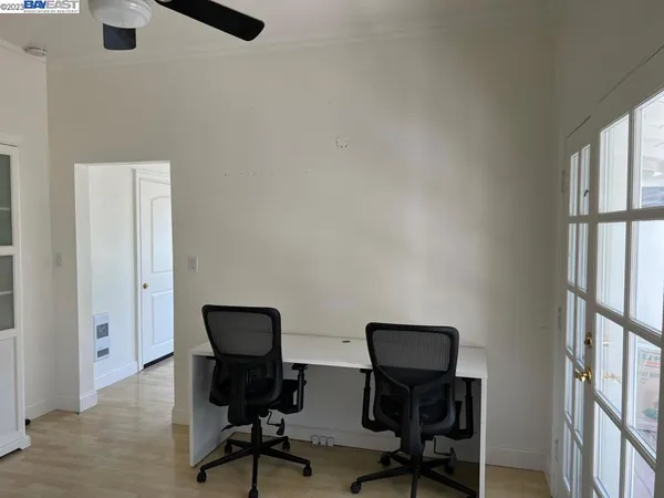 a view of a workspace with furniture and a window