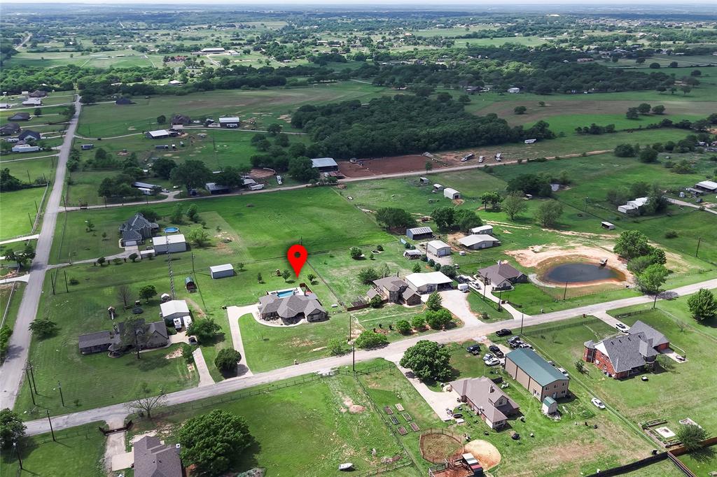 199 Newfield Lane Springtown, TX 76082 - Photo 36 of 38 This expansive property features extensive green lawn space, pool, putting green, playground, shop and a paved driveway.