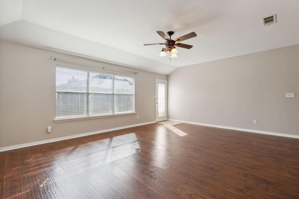 4401 Sycamore Road Melissa, TX 75454 - Photo 11 of 22 a view of an empty room with a window and wooden floor
