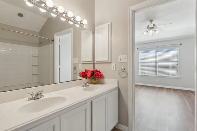 a bathroom with a sink vanity tub and shower