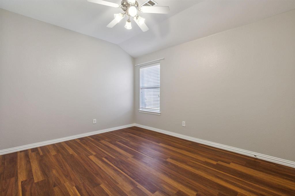 4401 Sycamore Road Melissa, TX 75454 - Photo 17 of 22 a view of an empty room with wooden floor and a chandelier fan