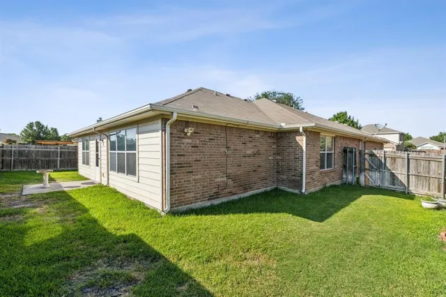 a view of a house with a yard and sitting area