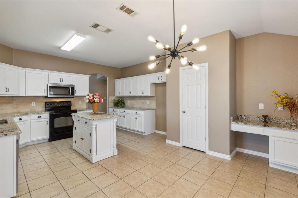4401 Sycamore Road Melissa, TX 75454 - Photo 7 of 22 a kitchen with cabinets and chairs
