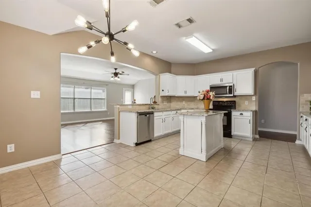 a kitchen with cabinets and stainless steel appliances