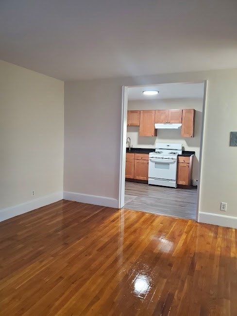 9 Victory Road, Unit 13 Boston, MA 02122 - Photo 1 of 14 a living room with a wooden floor