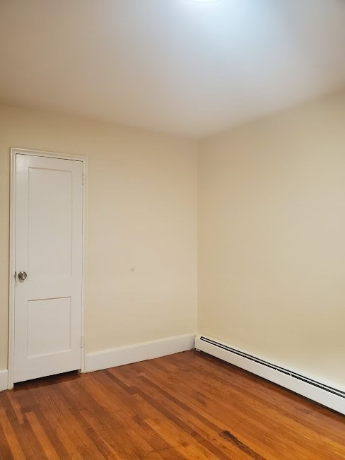9 Victory Road, Unit 13 Boston, MA 02122 - Photo 13 of 14 a view of an empty room with wooden floor and a window