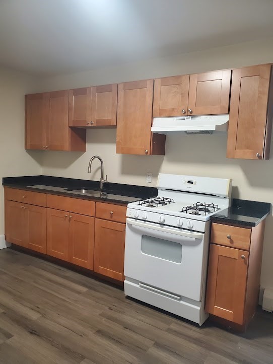 9 Victory Road, Unit 13 Boston, MA 02122 - Photo 2 of 14 a kitchen with a stove and a sink