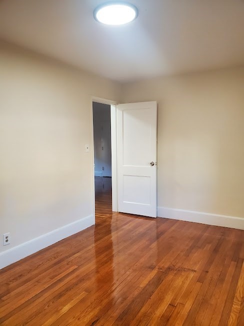 9 Victory Road, Unit 13 Boston, MA 02122 - Photo 8 of 14 a view of an empty room with wooden floor