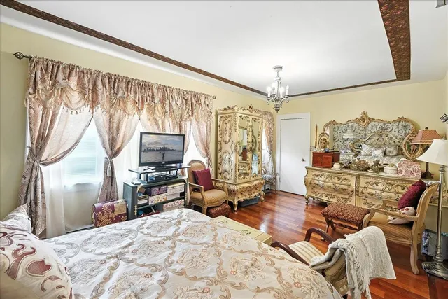 a bedroom with furniture and wooden floor