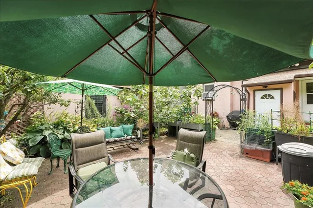 a view of a table and chairs under an umbrella