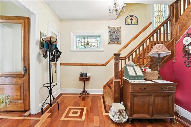 a living room with furniture a chandelier and a dining table