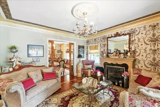a living room with furniture and a chandelier