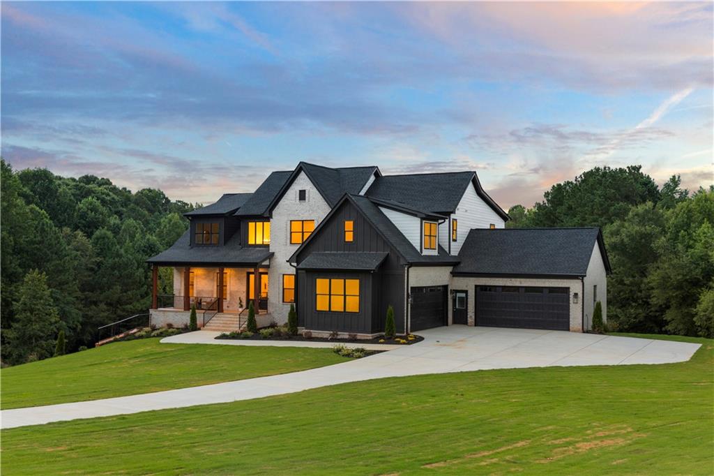 a front view of a house with a garden and yard