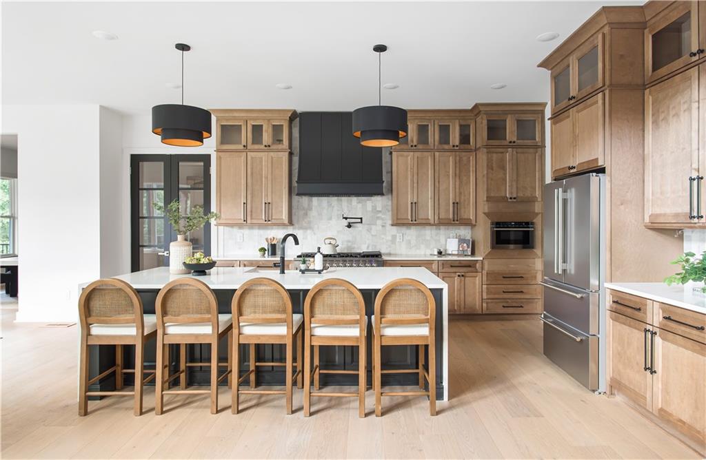 3300 Jack Glass Road Monroe, GA 30656 - Photo 14 of 54 a kitchen with stainless steel appliances granite countertop a stove top oven a refrigerator and cabinets