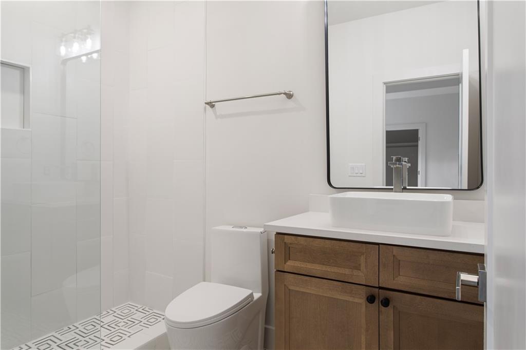 3300 Jack Glass Road Monroe, GA 30656 - Photo 25 of 54 a bathroom with a toilet sink and mirror