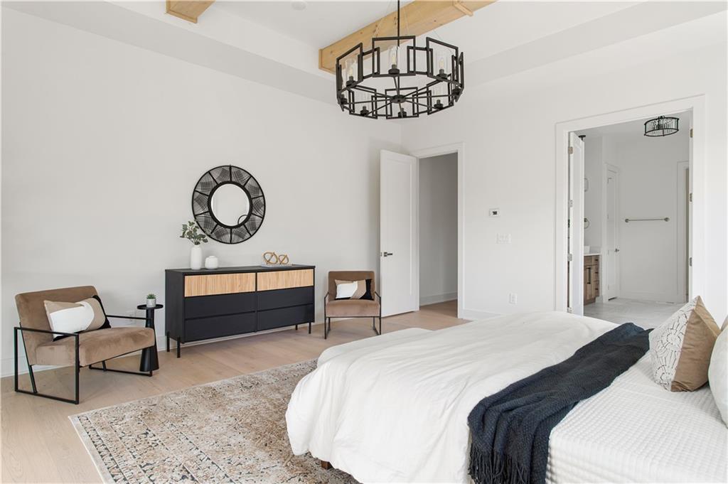 3300 Jack Glass Road Monroe, GA 30656 - Photo 39 of 54 a bedroom with a bed a chandelier and a dresser in it