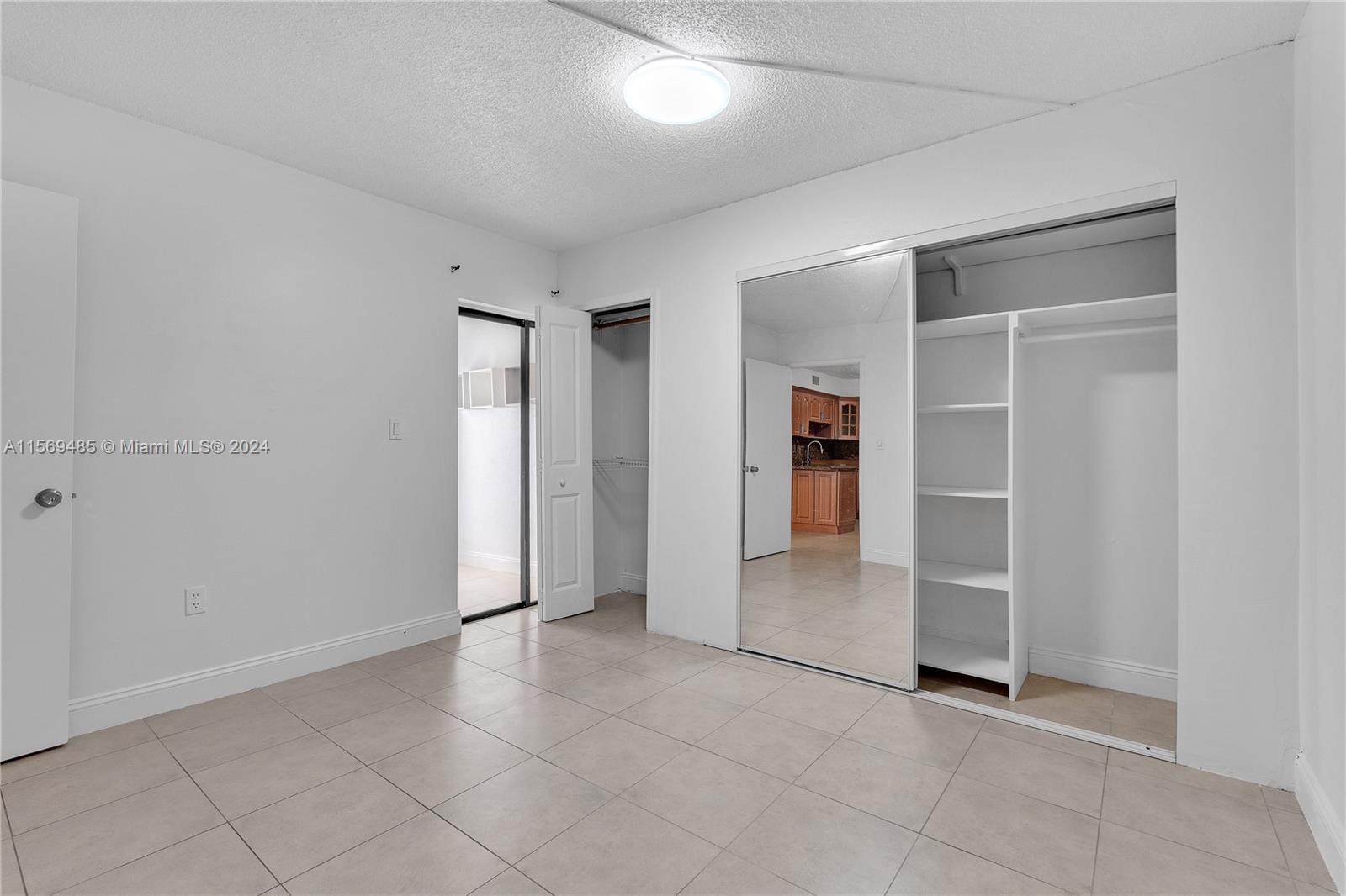 7540 Southwest 153rd Place, Unit 1029 Miami, FL 33193 - Photo 25 of 28 an empty room with closet and windows
