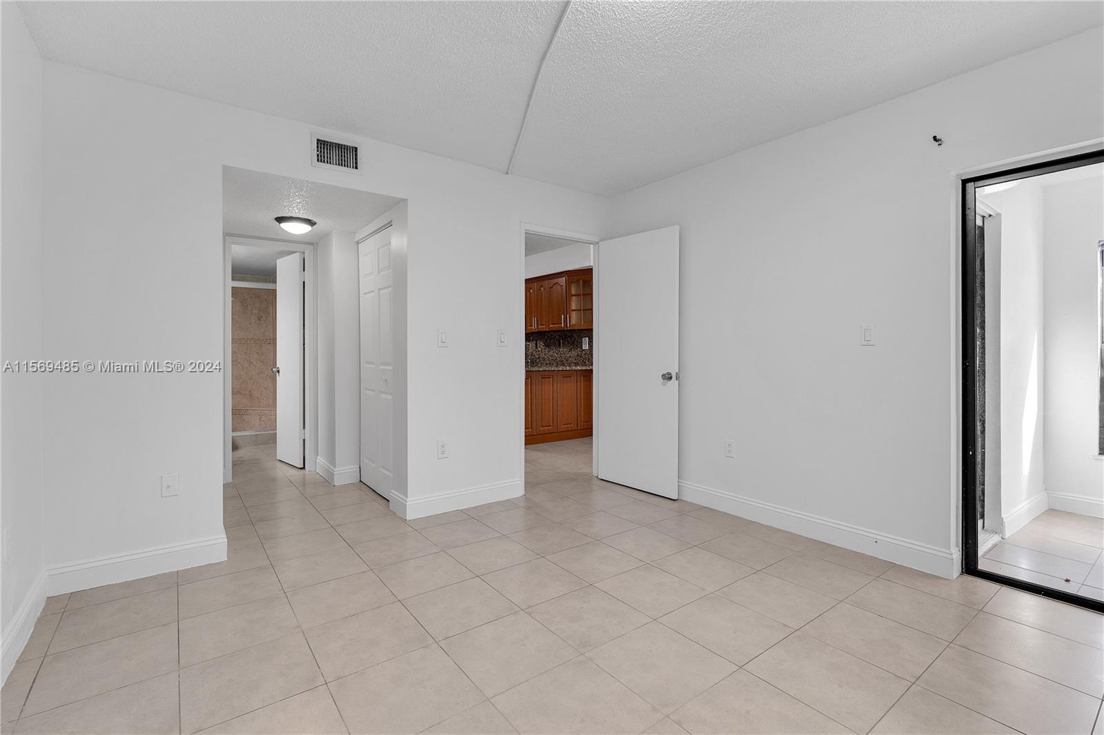 7540 Southwest 153rd Place, Unit 1029 Miami, FL 33193 - Photo 26 of 28 an empty room with closet and a bathroom