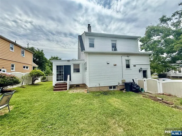 a view of a house with a yard and sitting area