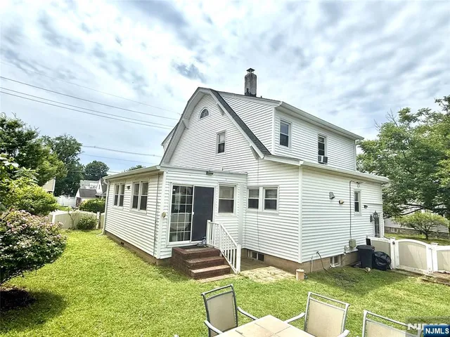 a front view of a house with a yard table and chairs