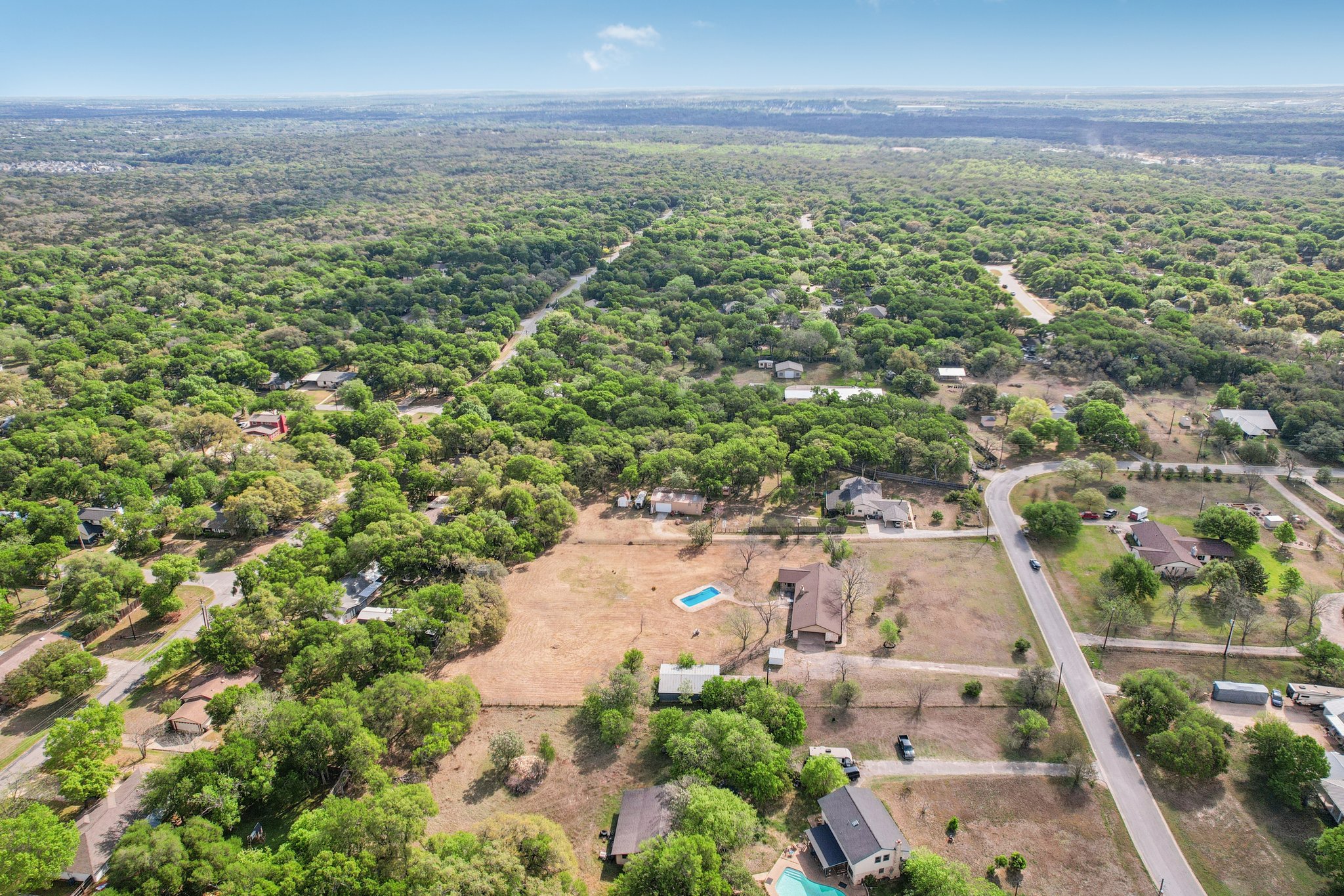 504 Buckaroo Trail Buda, TX 78610 - Photo 33 of 39 Drone / aerial view of a heavily wooded area