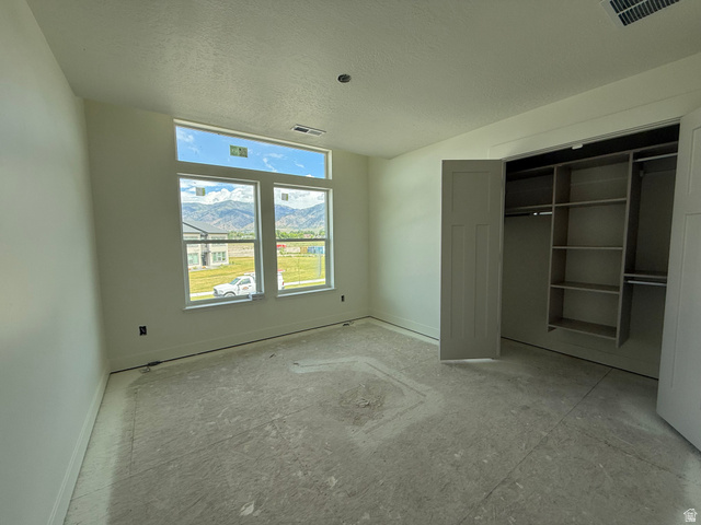 1008 West 3410 South Nibley, UT 84321 - Photo 19 of 26 Spacious room with multiple windows, including a transom window, offering abundant natural light