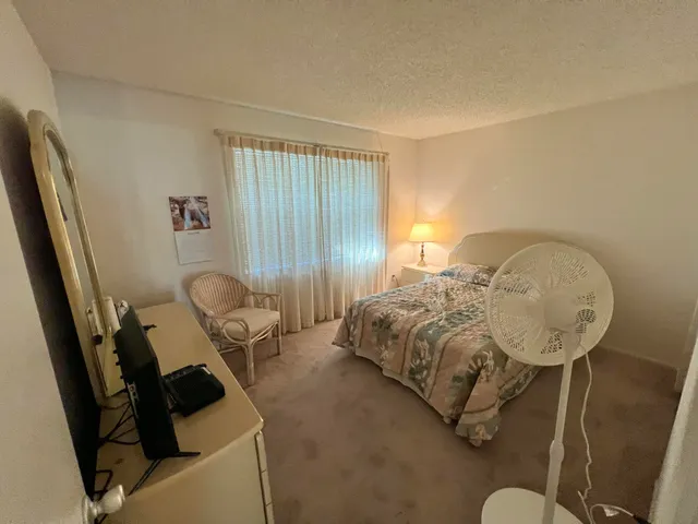 a bedroom with bed and a window