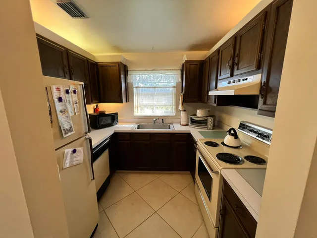 a kitchen with a sink a stove and refrigerator