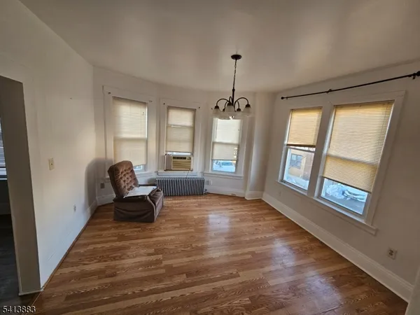 a view of a livingroom with wooden floor and a window