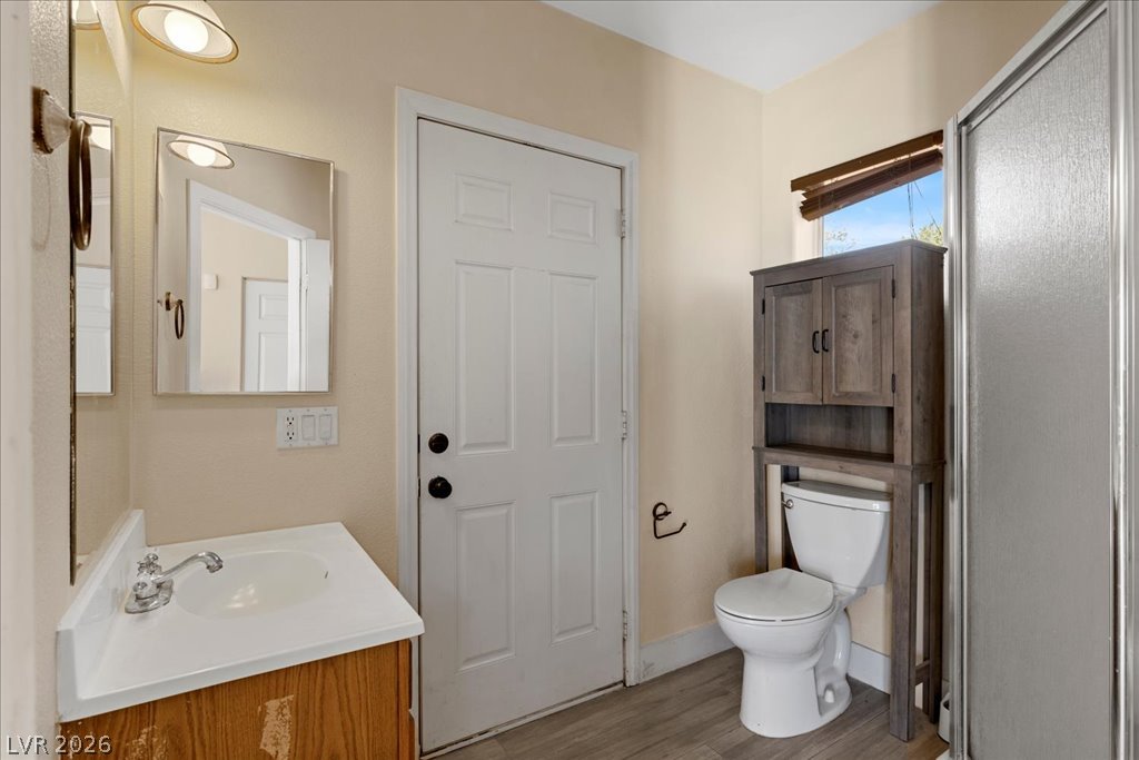 120 Ringlore Road Henderson, NV 89015 - Photo 40 of 58 Functional bathroom layout features a glass-enclosed shower stall and vinyl plank flooring.