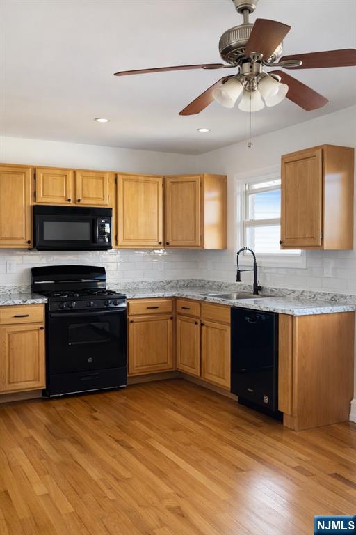 2755 Morris Avenue, Unit 2 Union, NJ 07083 - Photo 2 of 8 a kitchen with stainless steel appliances granite countertop a sink dishwasher stove and oven with wooden floor