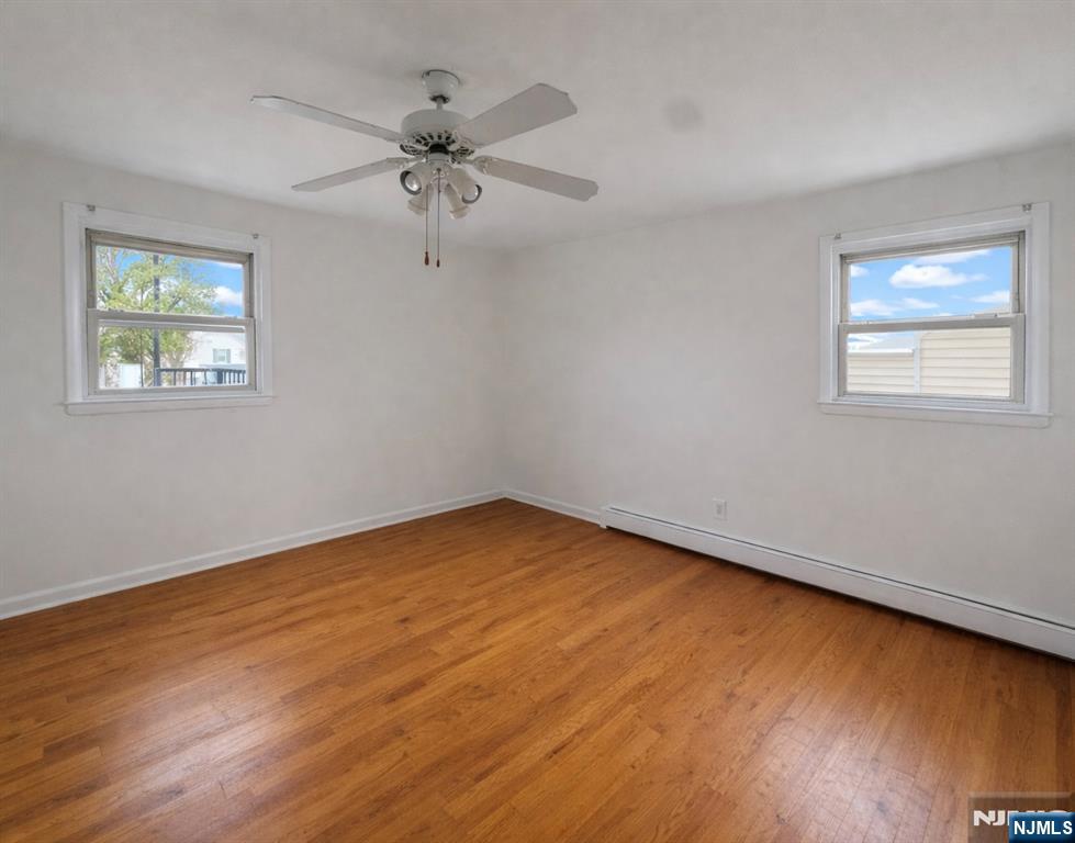 2755 Morris Avenue, Unit 2 Union, NJ 07083 - Photo 5 of 8 wooden floor in an empty room with a window
