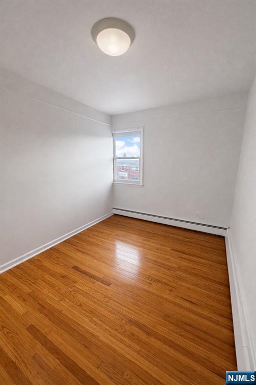 2755 Morris Avenue, Unit 2 Union, NJ 07083 - Photo 6 of 8 an empty room with wooden floor and windows