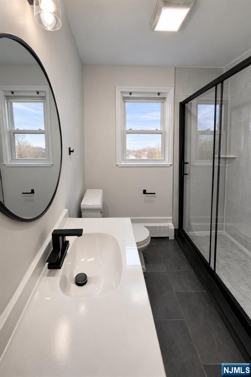 2755 Morris Avenue, Unit 2 Union, NJ 07083 - Photo 7 of 8 a bathroom with a sink a toilet and mirror