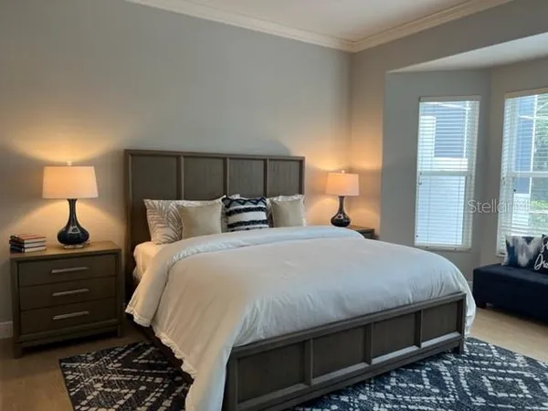 a bedroom with a bed and a television