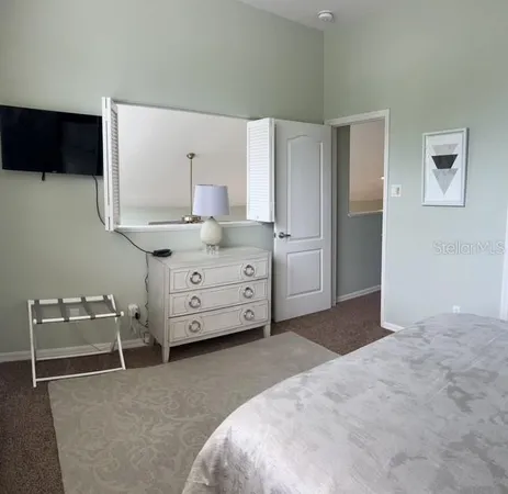 a bathroom with a double vanity sink a toilet and a mirror