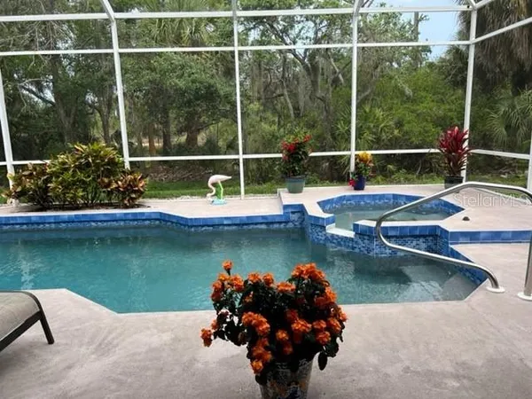 a view of a swimming pool with a lounge chair