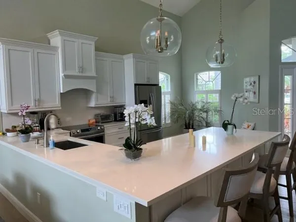 a kitchen with a dining table and chairs