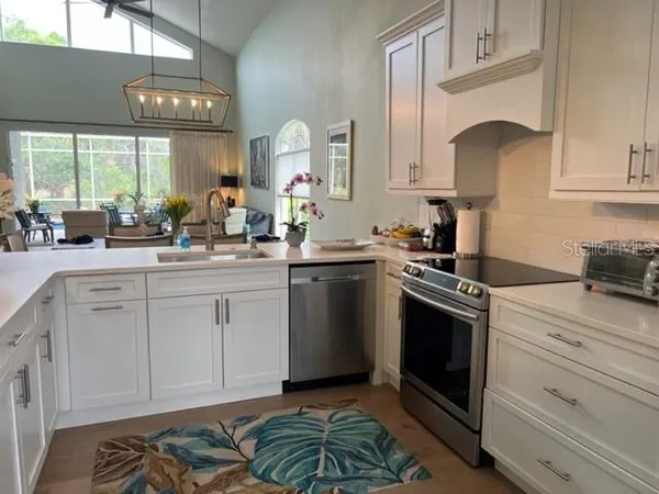 a kitchen with a stove sink and cabinets