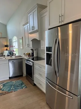 a kitchen with stainless steel appliances a refrigerator sink and cabinets