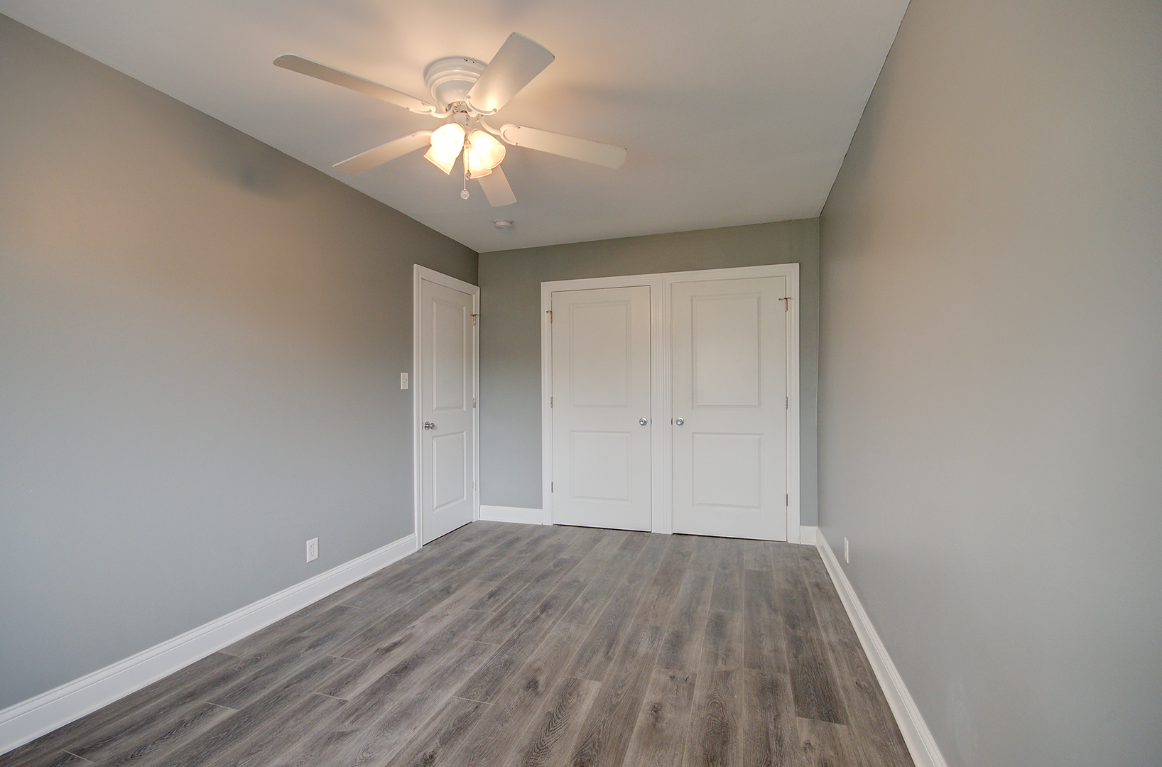 2302 Carnation Drive, Unit 317C Crest Hill, IL 60403 - Photo 13 of 17 a view of a room with wooden floor and a ceiling fan