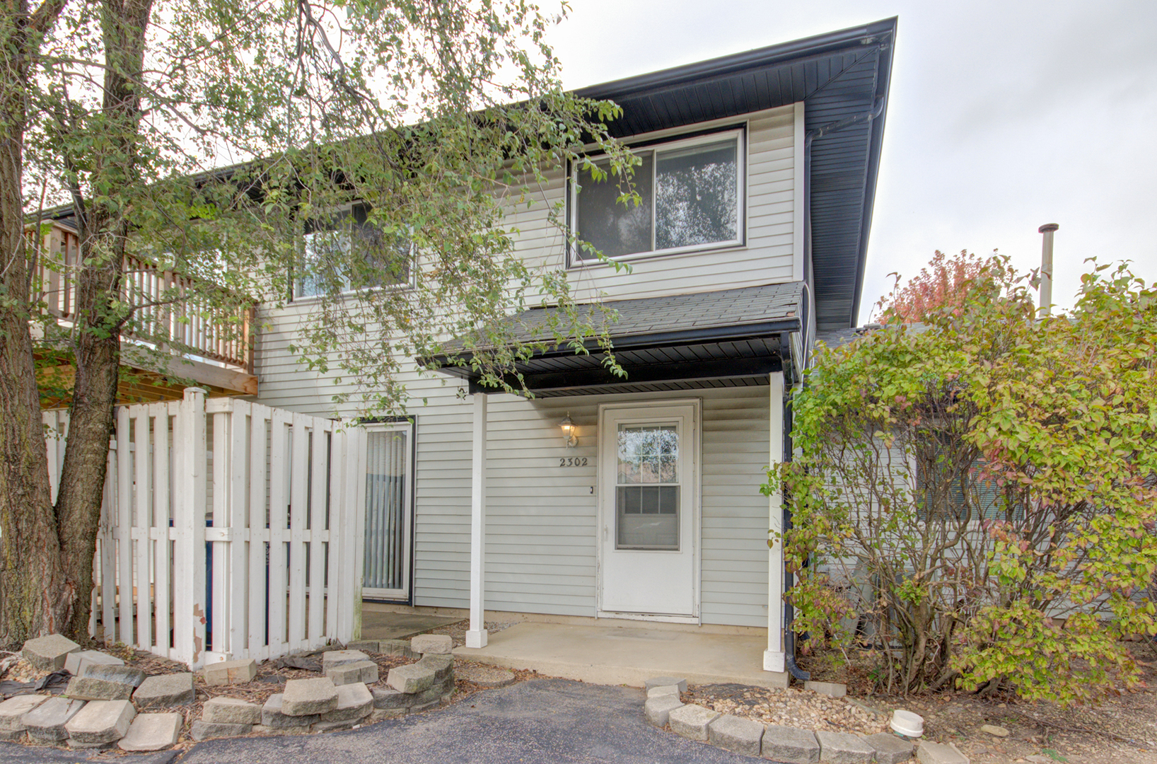 2302 Carnation Drive, Unit 317C Crest Hill, IL 60403 - Photo 16 of 17 a front view of a house with a tree