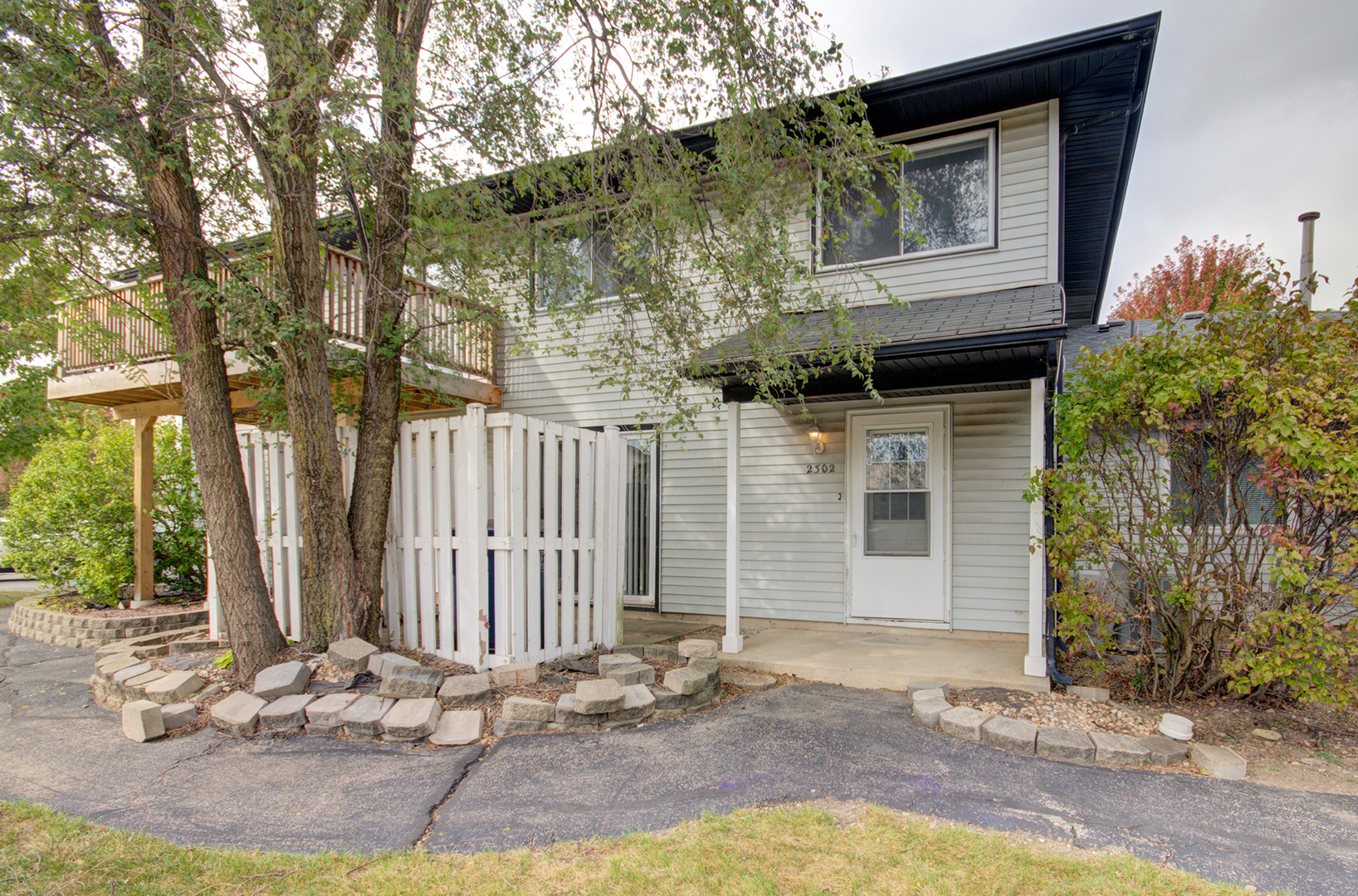 2302 Carnation Drive, Unit 317C Crest Hill, IL 60403 - Photo 17 of 17 a front view of a house with garden